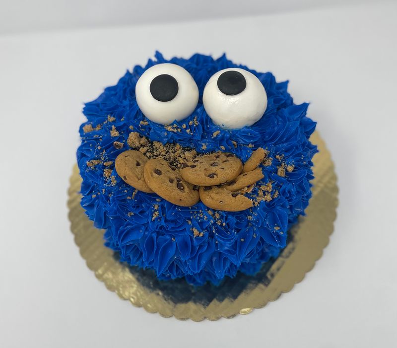 Blue Cookie Monster cake with cookies on top