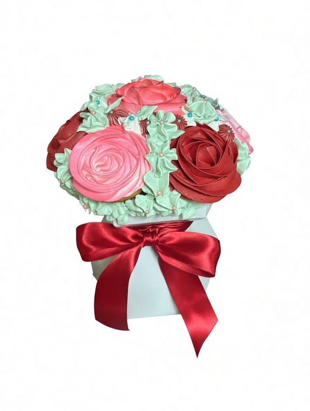 Cupcake bouquet of piped roses in a gift box with a red ribbon