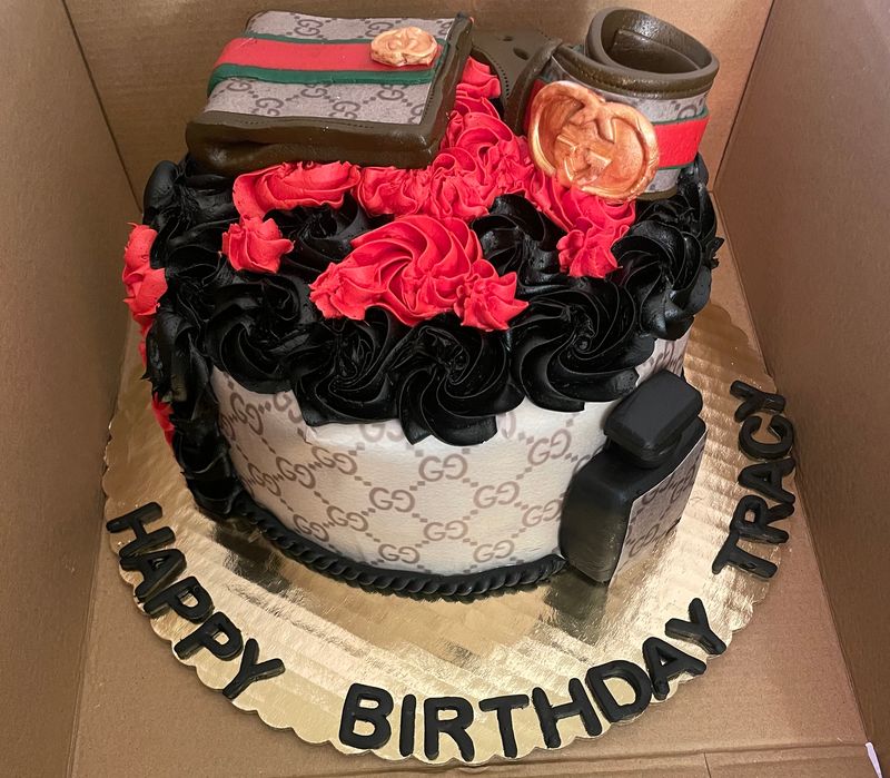 Designer-themed birthday cake in black, red and monogram print