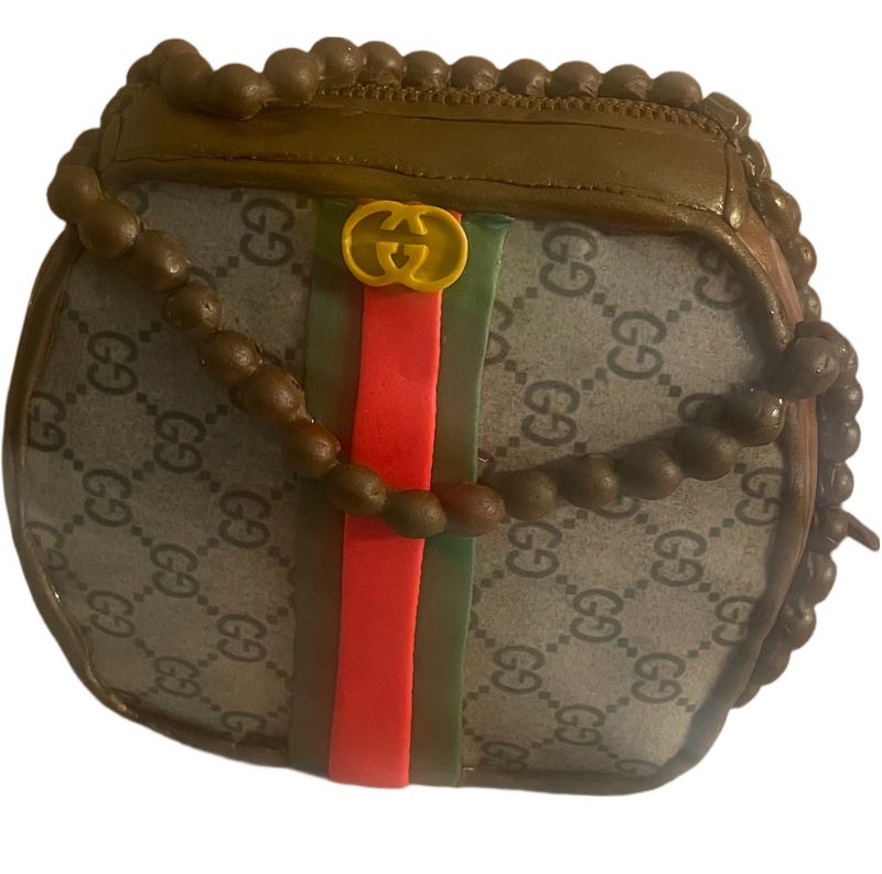 Sculpted designer handbag cake in monogram print with a red and green stripe