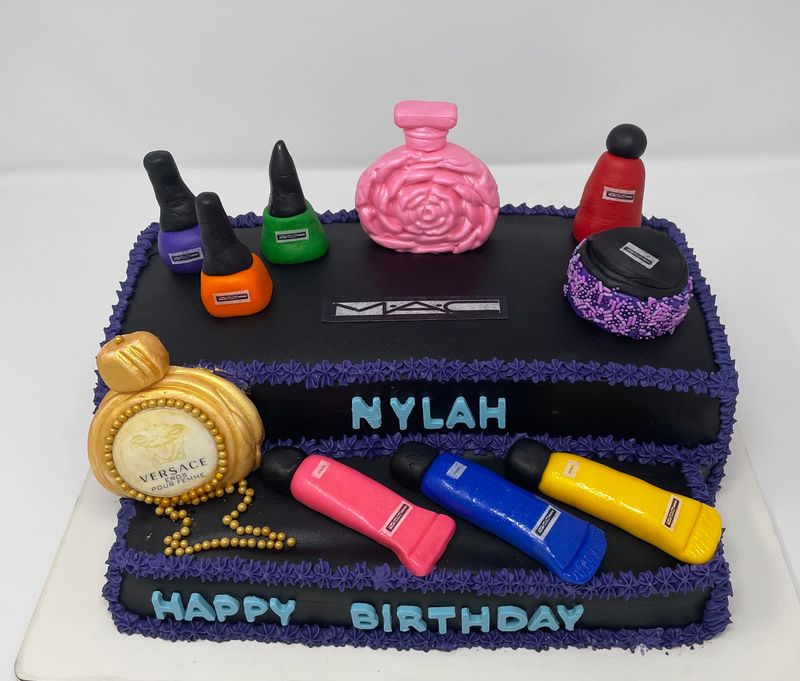 Birthday cake topped with sculpted makeup, nail polish and a perfume bottle