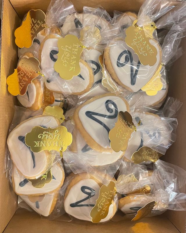 Iced sugar cookies bagged as favors with gold thank-you tags